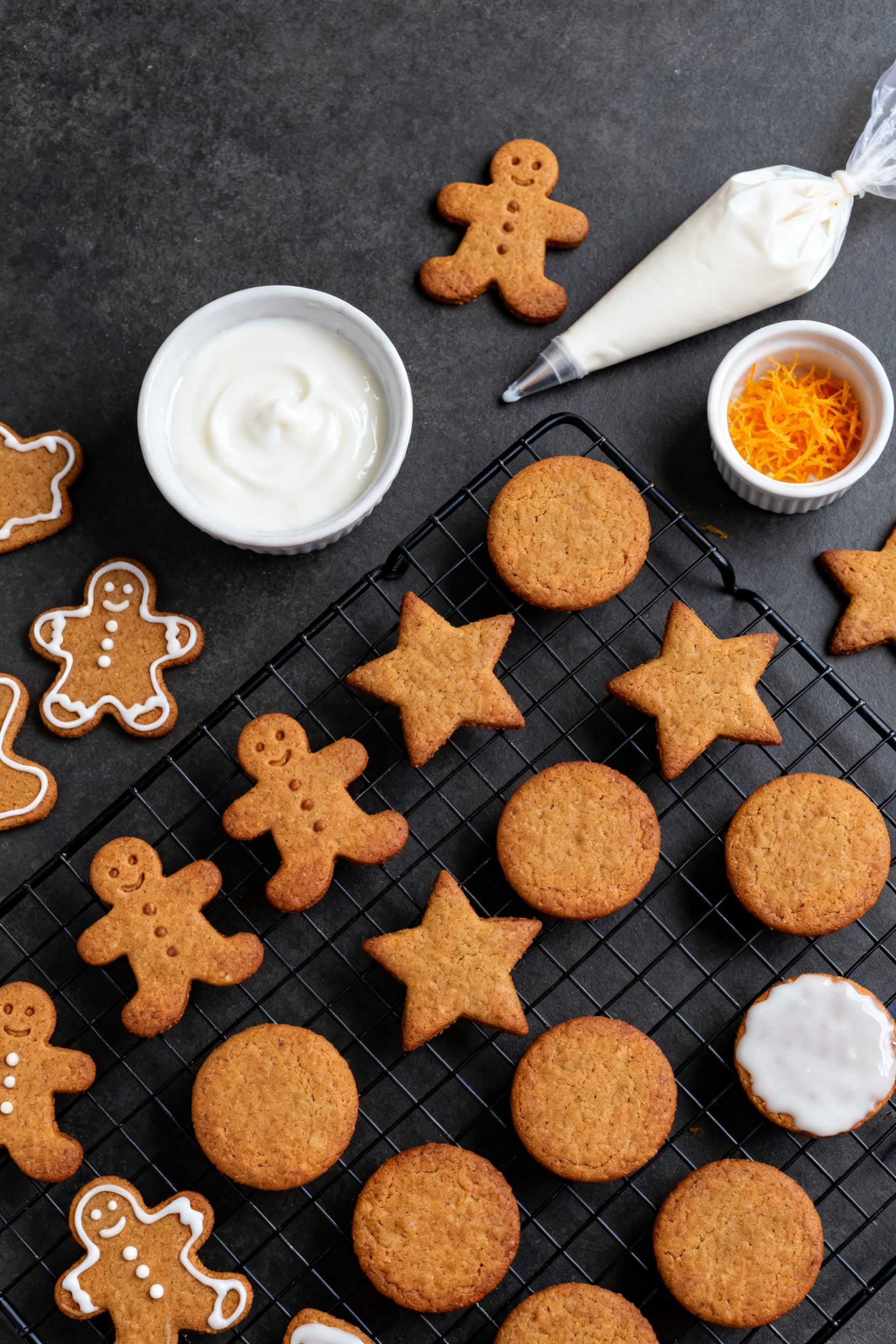 Overhead tasty top view: Cooling rack filled with assorted gingerbread cutouts (men, stars, rounds) 