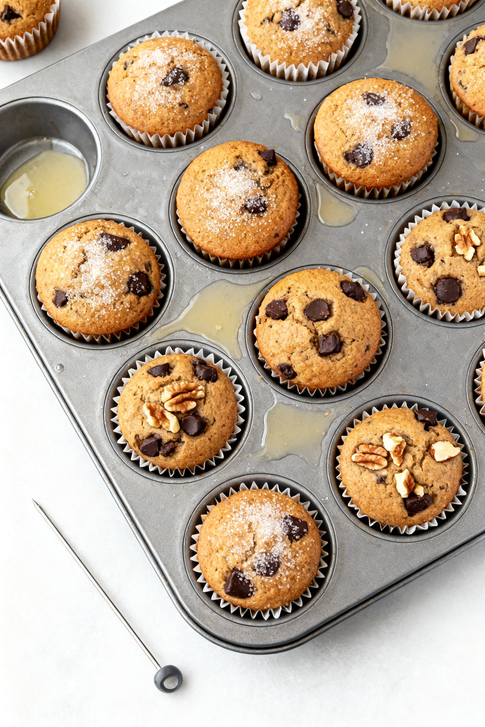 Tasty top view: Overhead shot of a 12-cup muffin pan fresh from the oven with domed, golden-brown ba